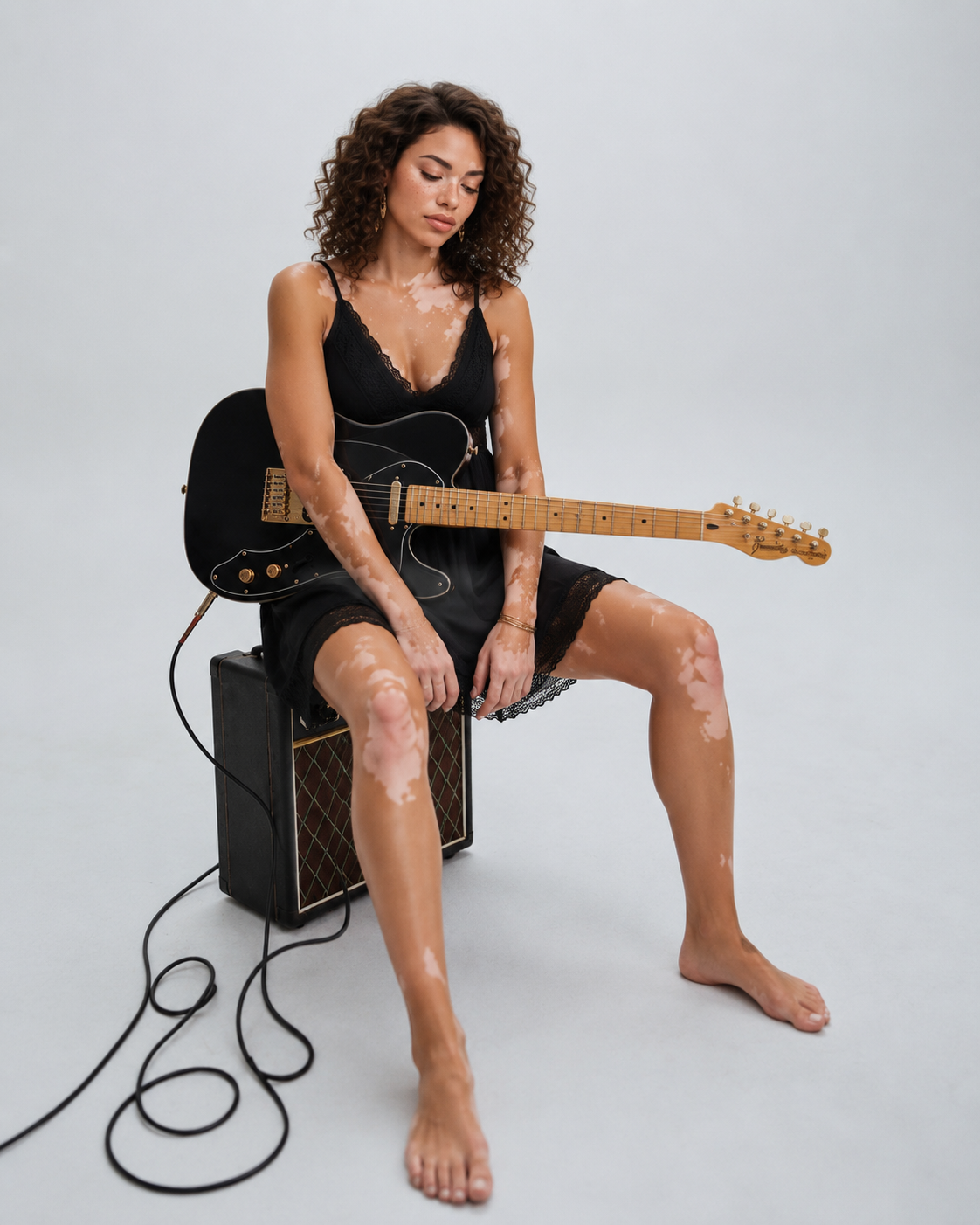 Sophia with a black telecaster on an amp